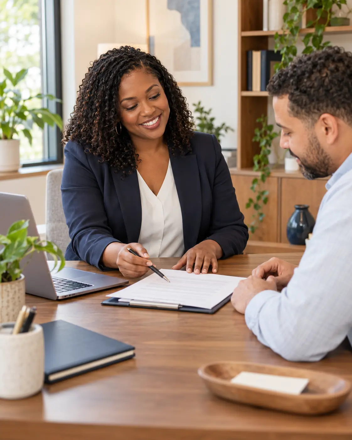 A friendly notary guiding a client through a document at a warm office desk
